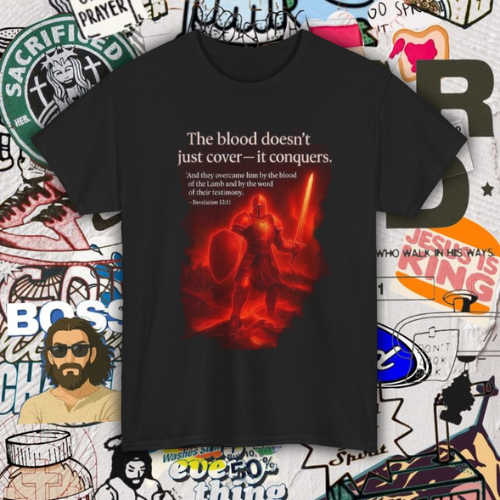 The Blood Doesn’t Just Cover — It Conquers” – Unisex Heavy Cotton Tee