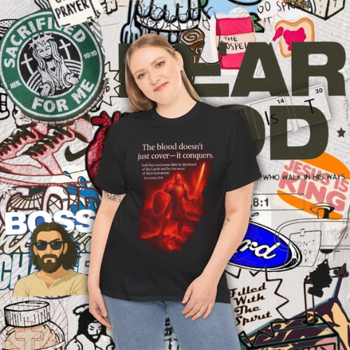 The Blood Doesn’t Just Cover — It Conquers” – Unisex Heavy Cotton Tee