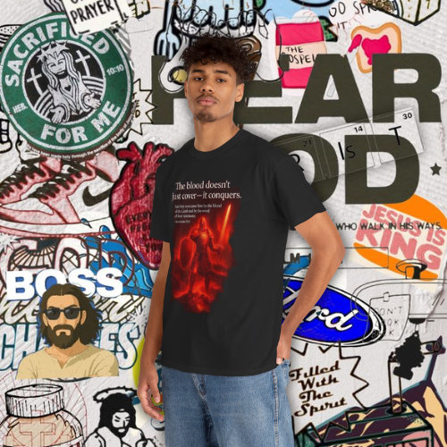 The Blood Doesn’t Just Cover — It Conquers” – Unisex Heavy Cotton Tee